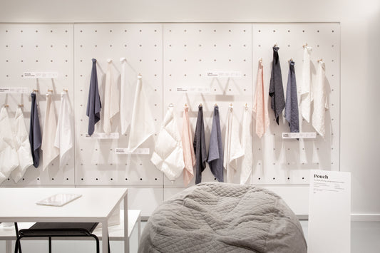 Picture of one of the walls inside a T&N Retail Store with samples of sheets hanging on the walls
