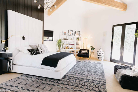 Keltie Knights black and white designed bedroom with wood ceiling beams