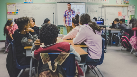 Classroom full of students looking at their teacher