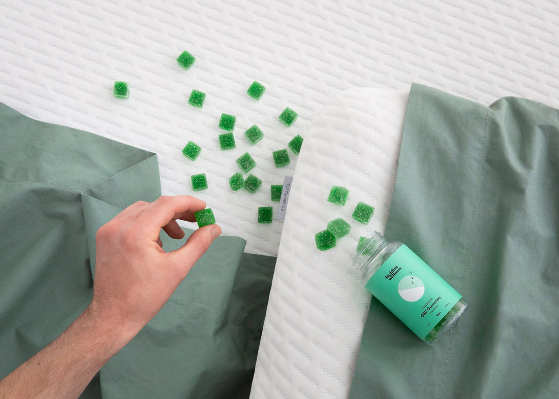 Highline Wellness gummies laid out on top of a Tuft & Needle mattress and foam pillow