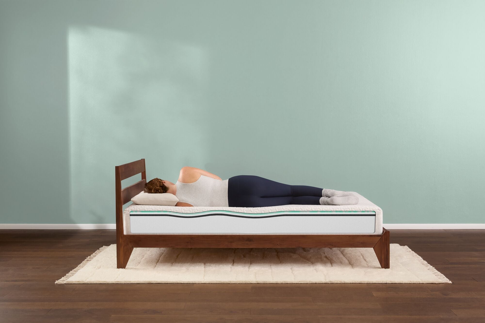 Man and woman laying in bed reading on a tuft  and needle original mattress