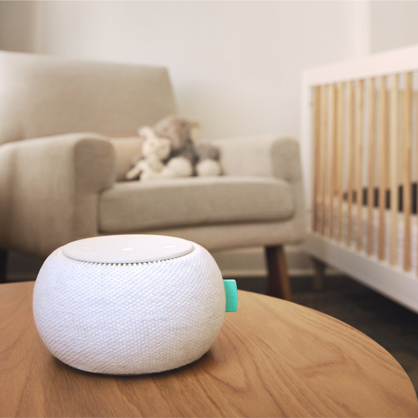 White noise machine sitting on on a brown table