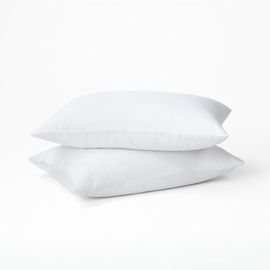 Two pillows dressed in the Tuft and Needle Hemp Pillowcase Set||color:cloud