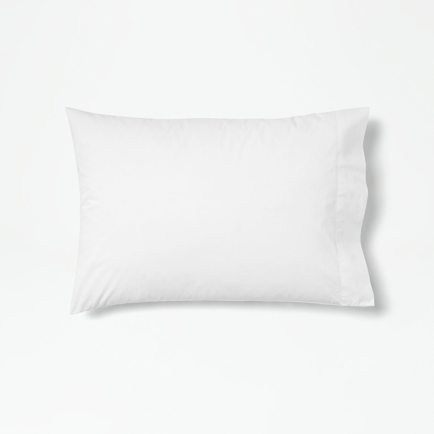 The Tuft and Needle Percale Pillowcase Set on one pillow||color:cloud