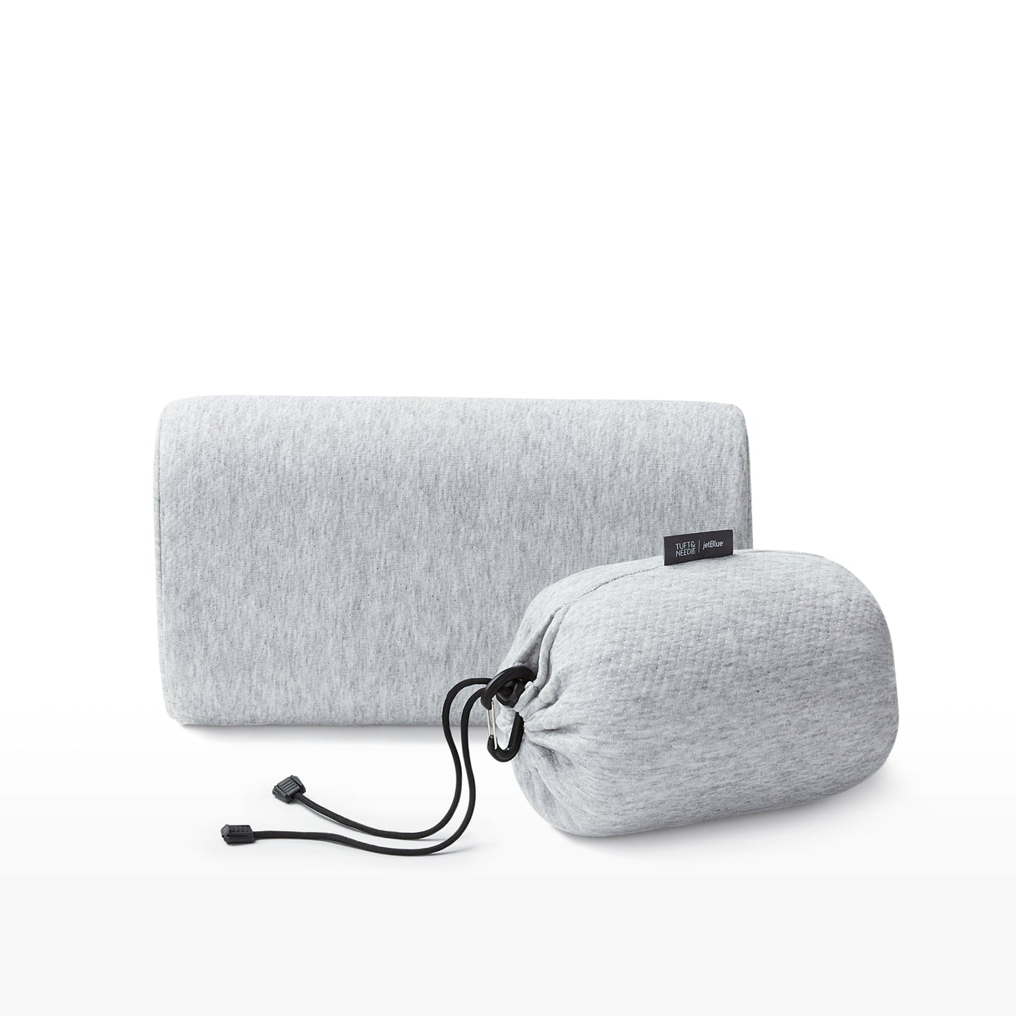 The Tuft and Needle Anywhere Travel pillow next to the carrying sack ||color:granite