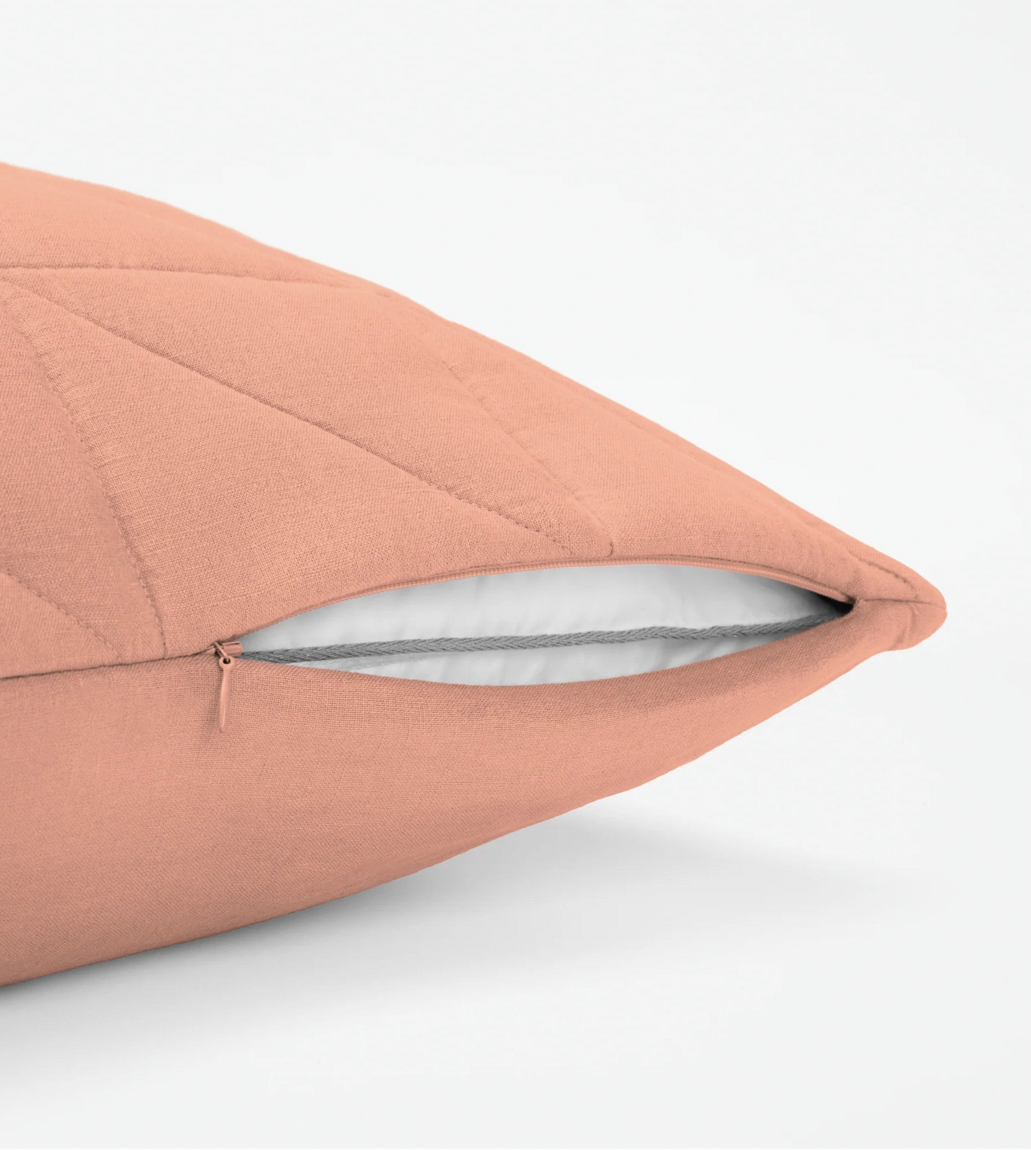 Up close image of a linen blent pillowcase getting zipped up on a pillow