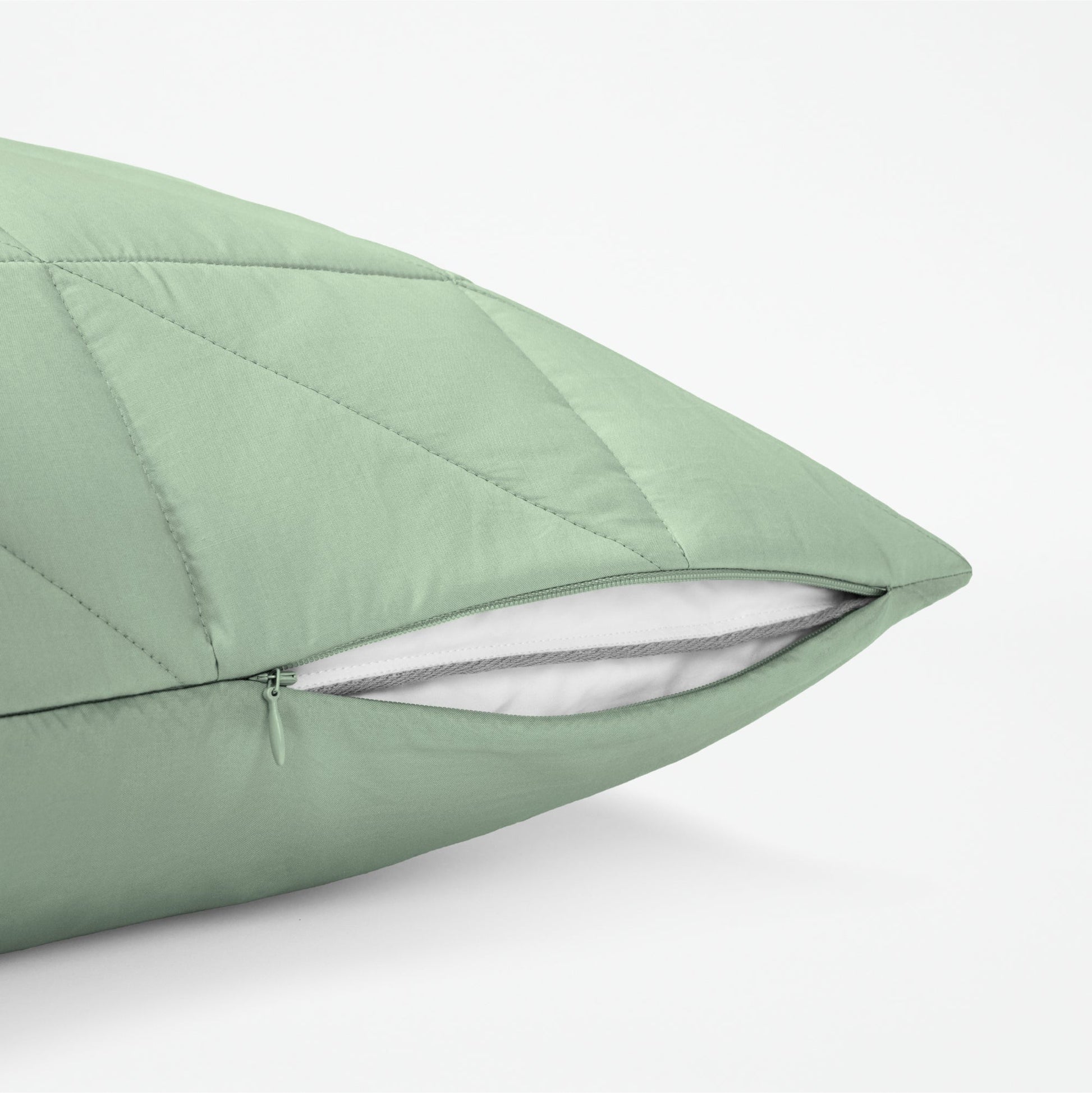 The Tuft and Needle Classic Percale Body Pillow Cover, showing a zipper slightly open to the pillow inside || color: Sage