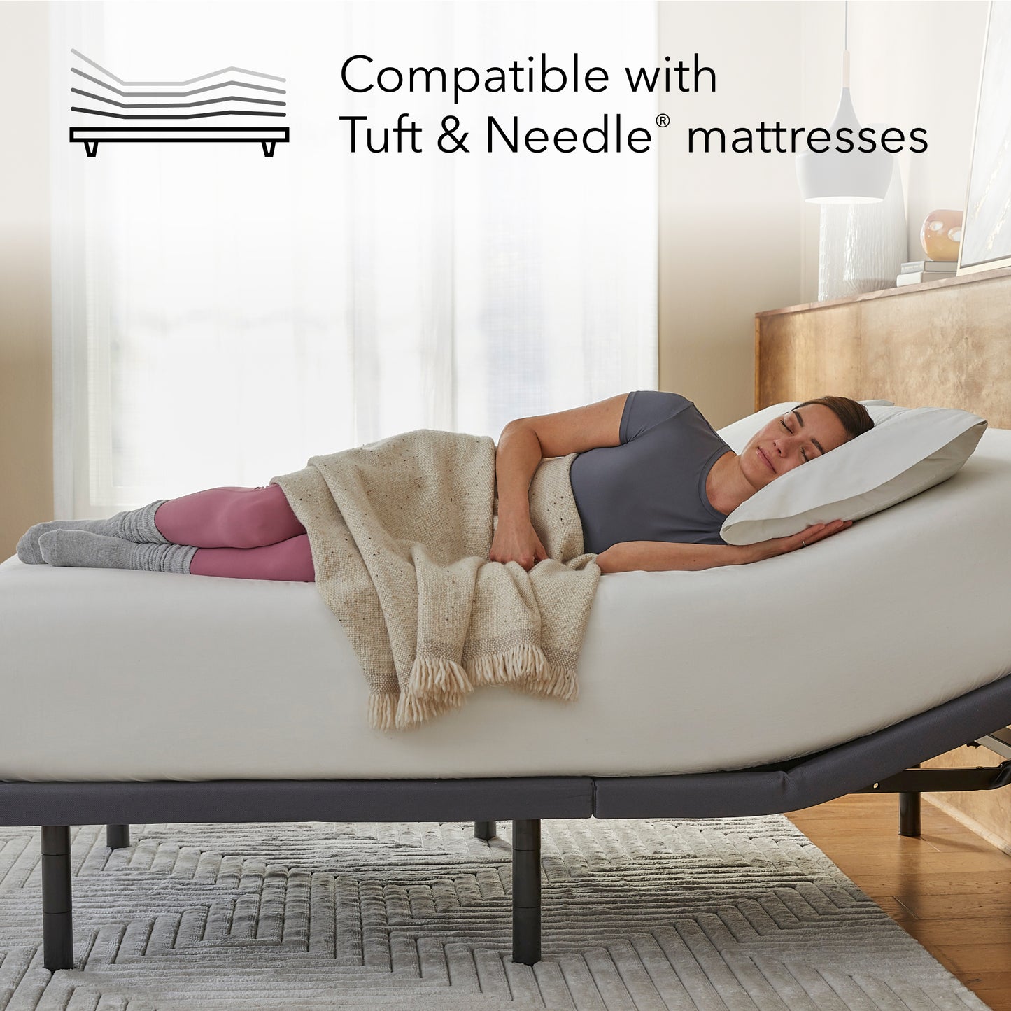 Woman laying asleep on a white mattress sitting on a Baselogic Gold Adjustable Base || level: Gold
