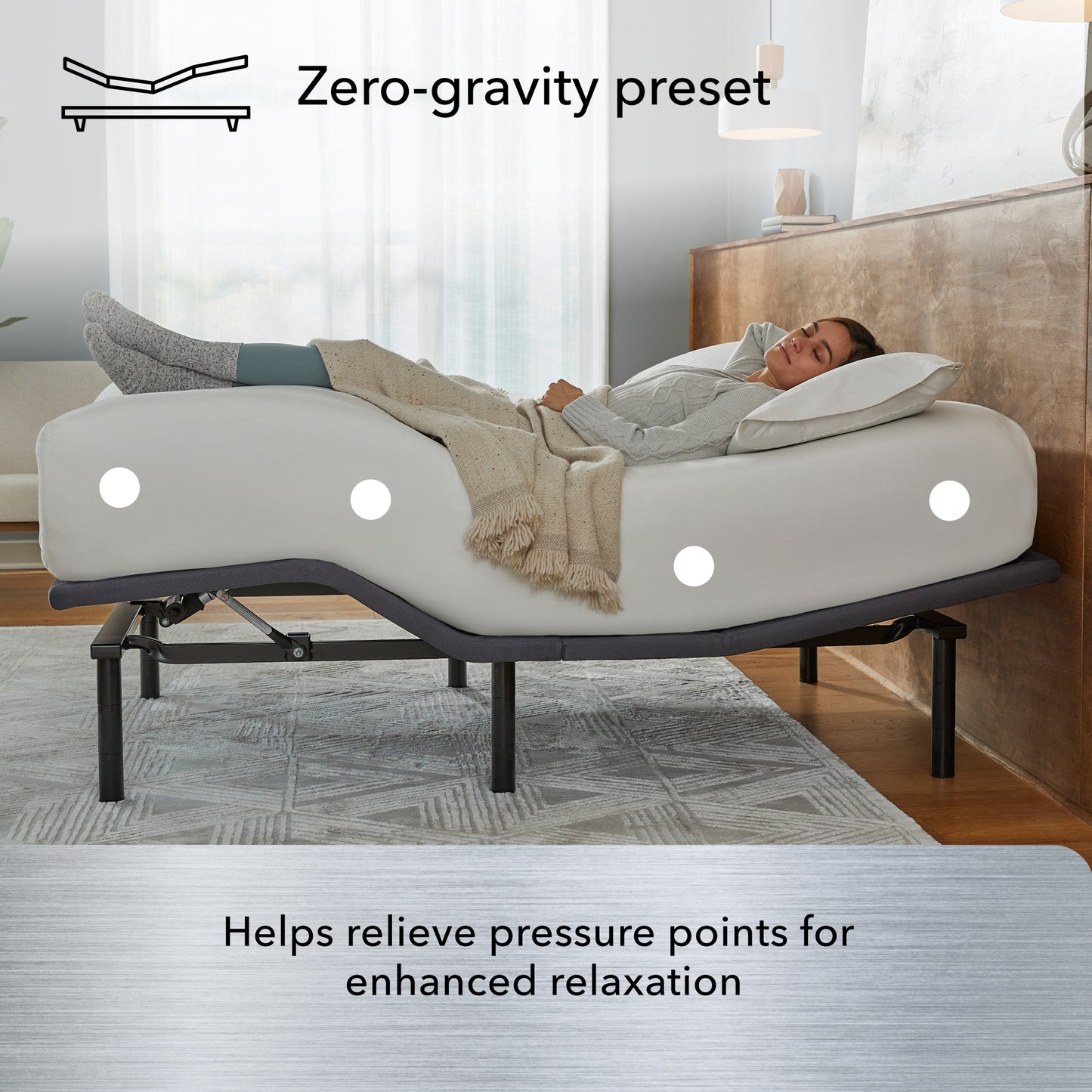 Woman laying asleep on a white mattress sitting on a Baselogic Silver Adjustable Base