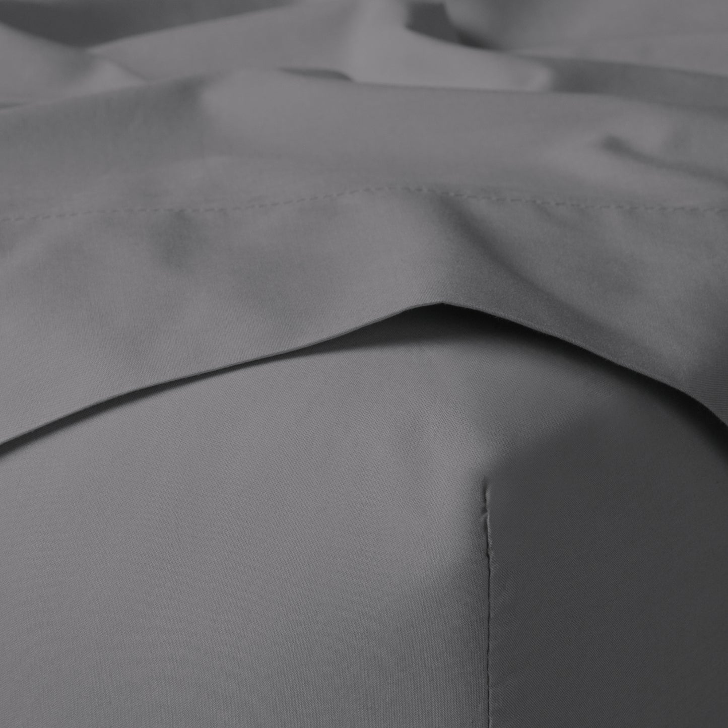 The Tuft and Needle Classic Percale Sheet Set, corner of a mattress with both sheets showing || color: Gray Quill