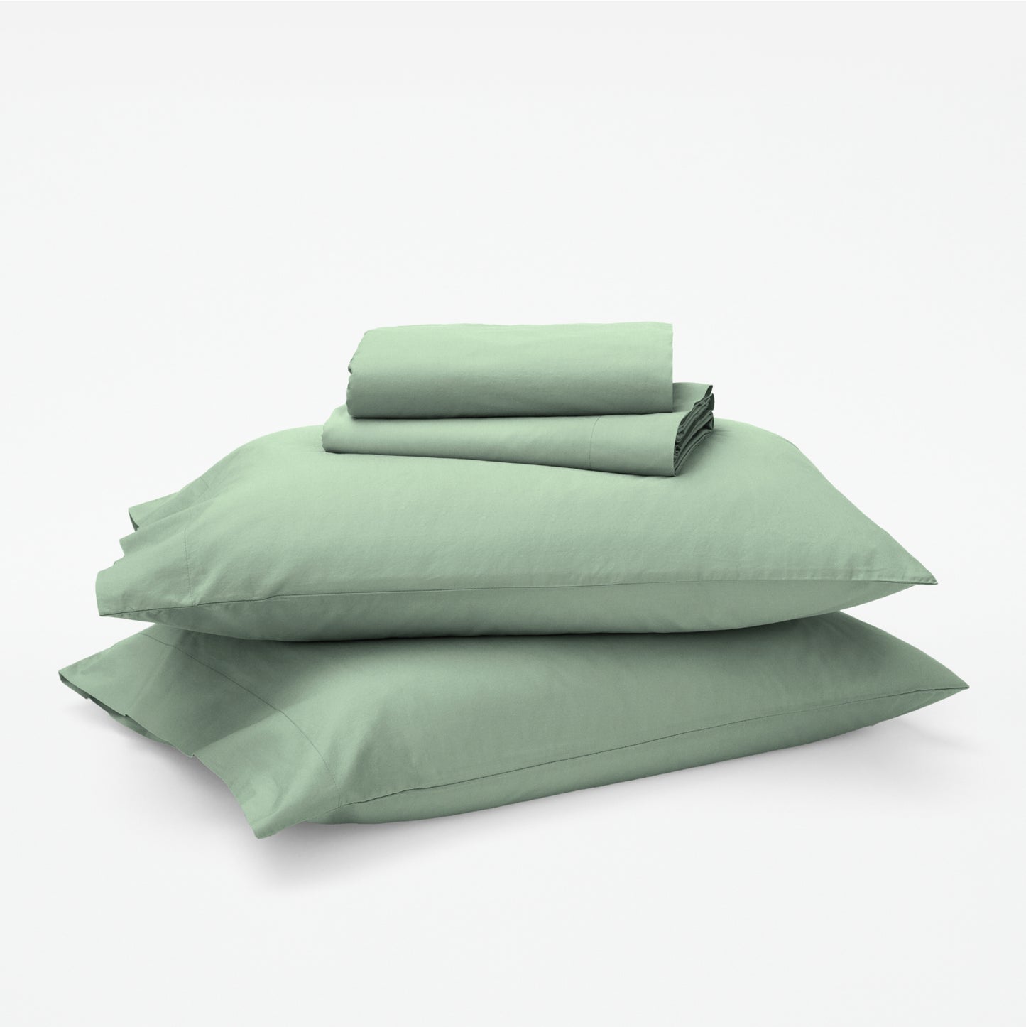 The Tuft and Needle Classic Percale Sheet Set, 1 sheet and pillowcases stacked on top of 2 pillows || color: Sage