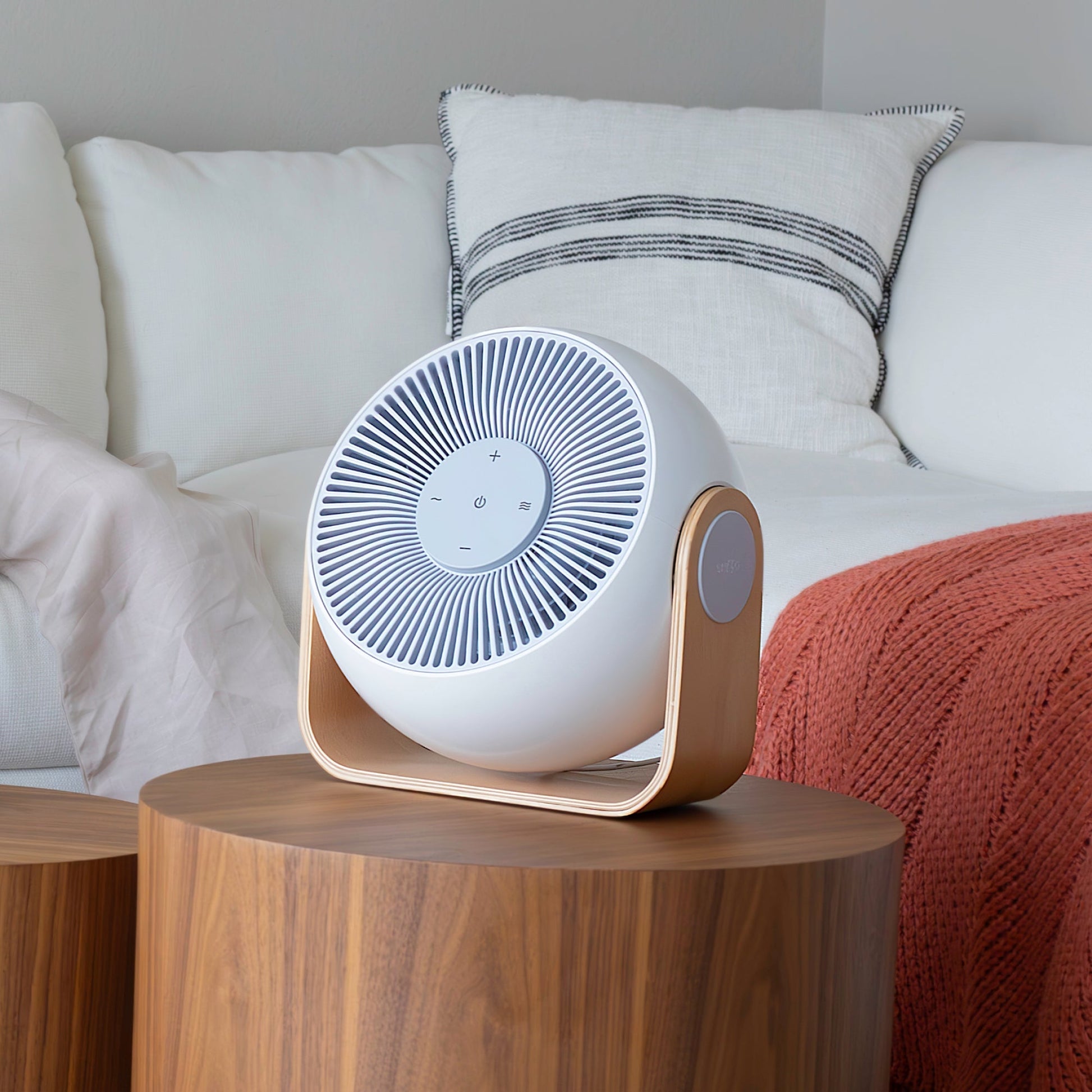 Snooz Breez Smart Bedroom Fan & White Noise Machine sitting on an end table