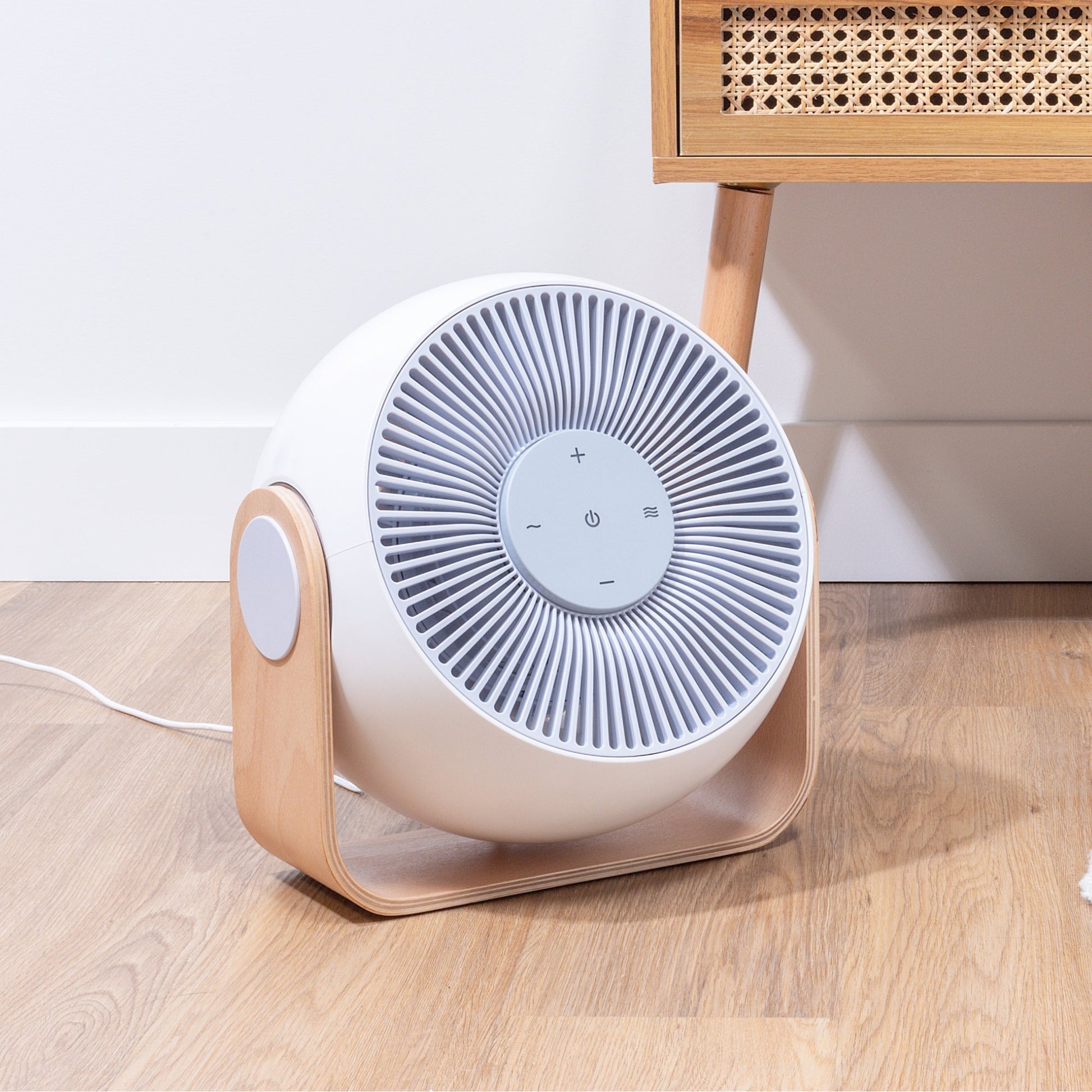 Snooz Breez Smart Bedroom Fan & White Noise Machine sitting on the floor turned to the right