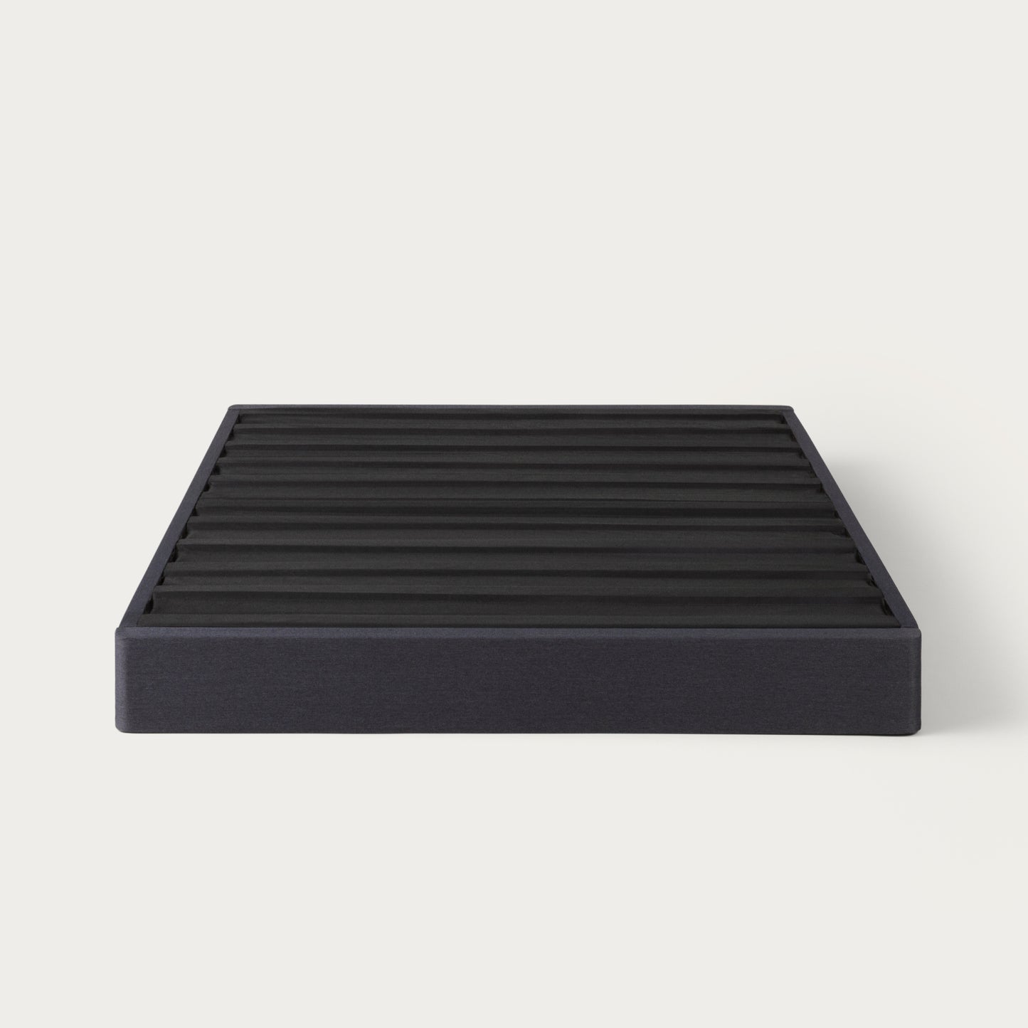 Tuft & Needle black colored mattress foundation on a white background