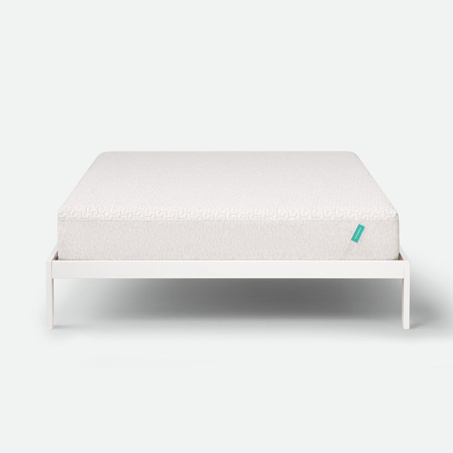 Tuft & Needle White mattress on a white frame with a visible brand logo on a white background