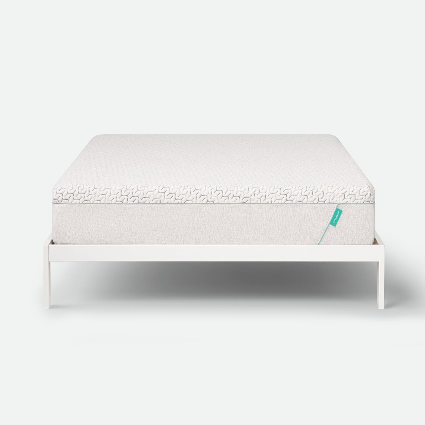 Tuft & Needle Mattress on a white stand with a white background