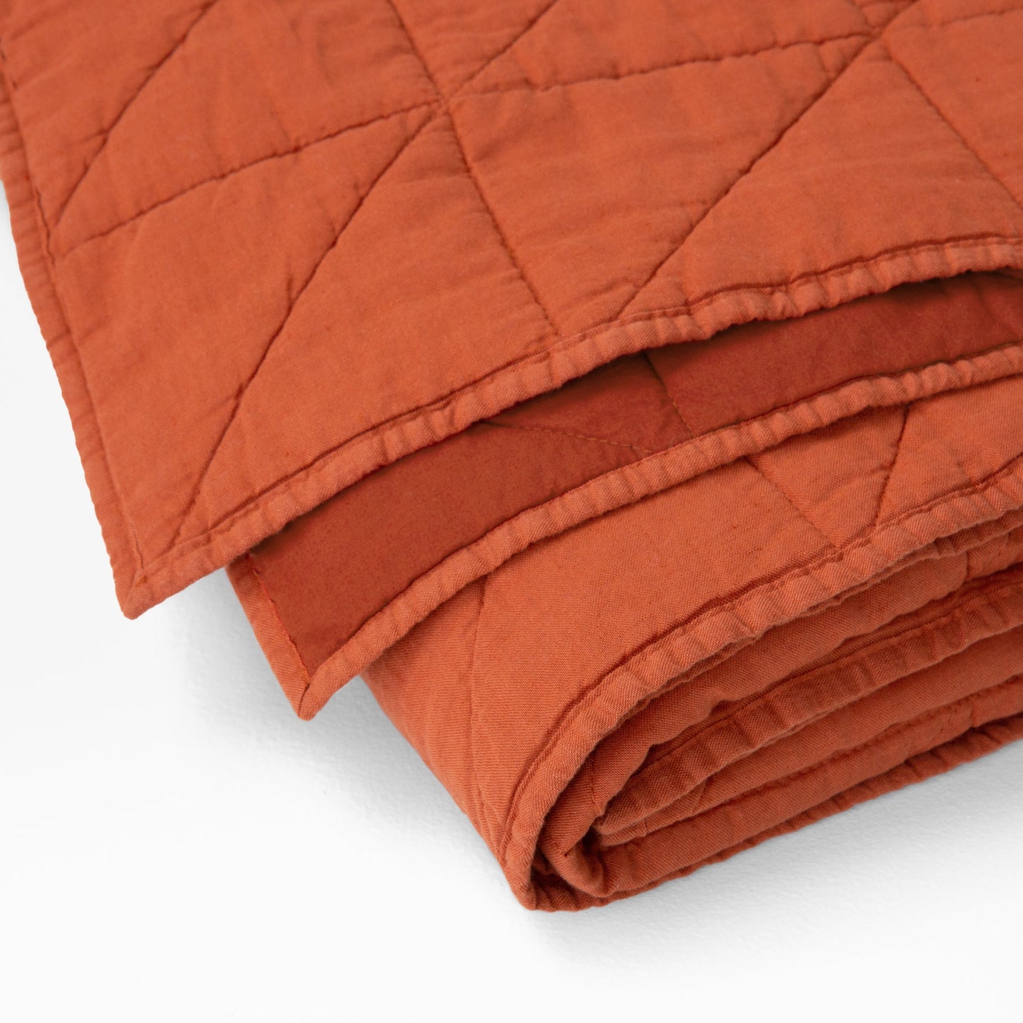 Corner detail of the Tuft and Needle Quilt||color:cayenne