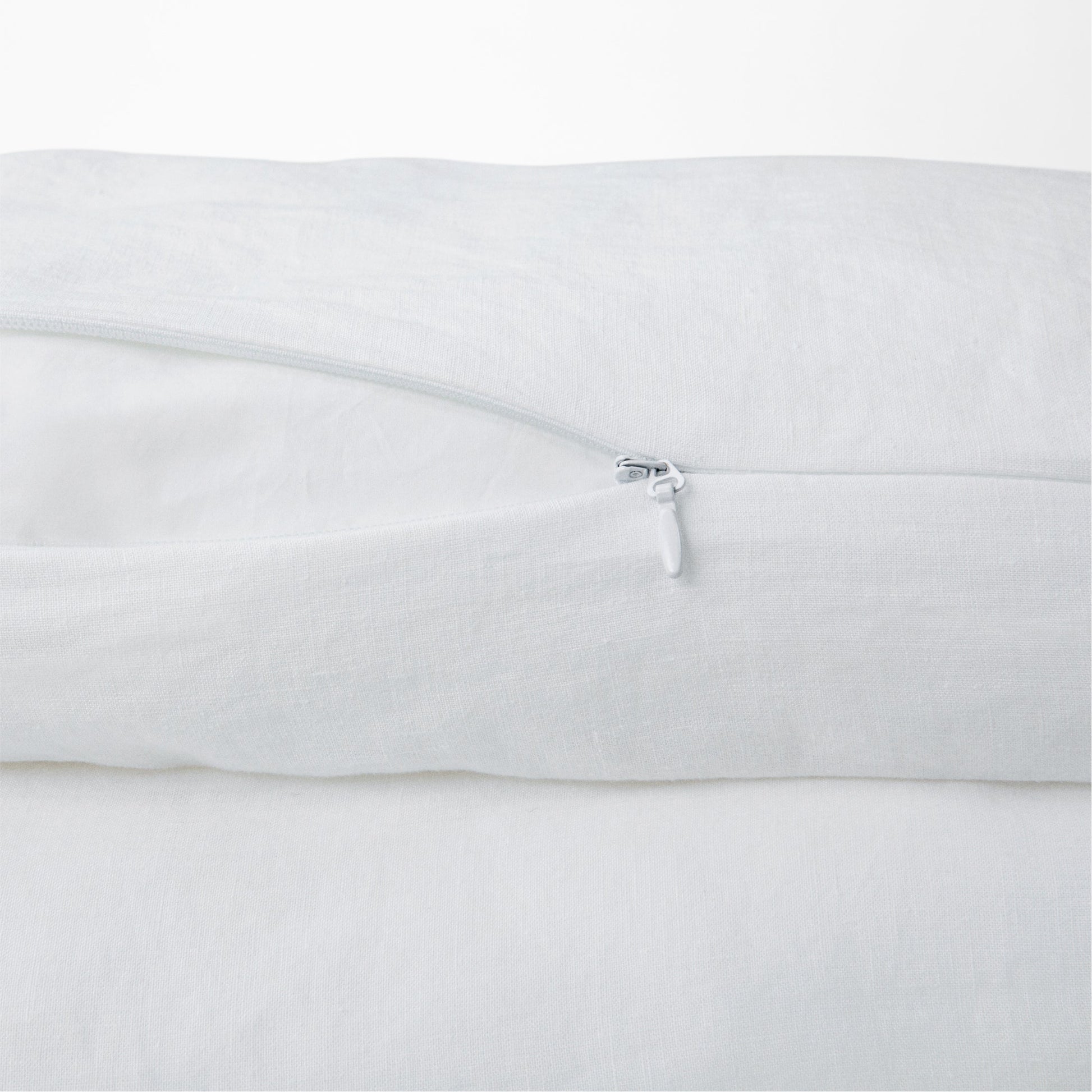 Close-up view of the zipper on the Tuft and Needle Hemp Duvet Cover ||color:honeycomb