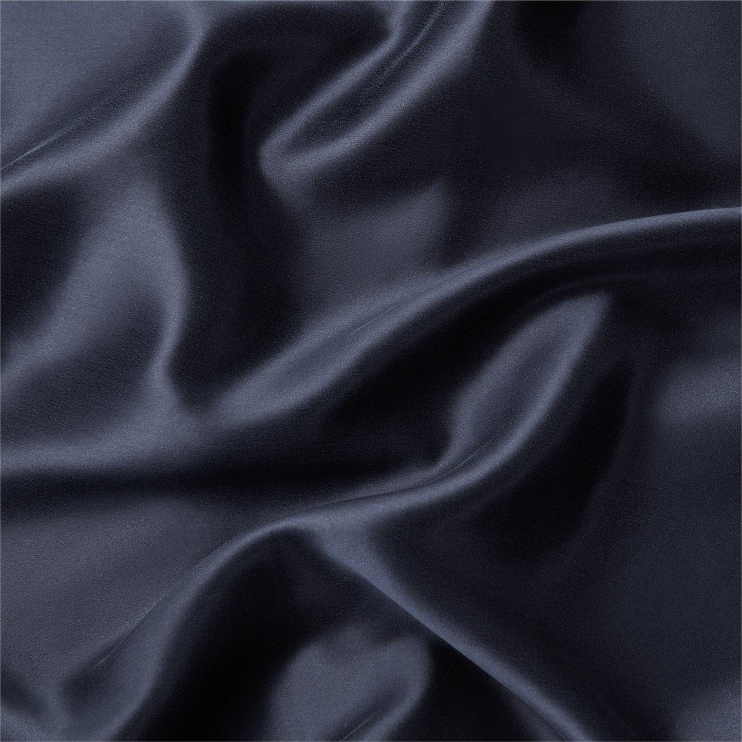 Close-up view of the fabric on the Tuft and Needle Silk Pillowcase ||color:midnight