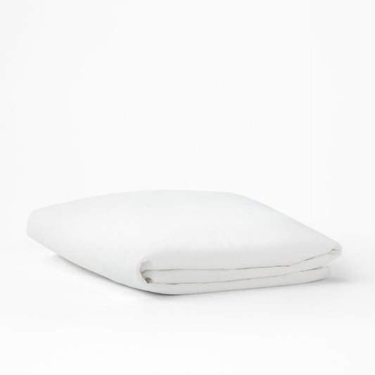 The Tuft and Needle Mattress Protector folded on a white background