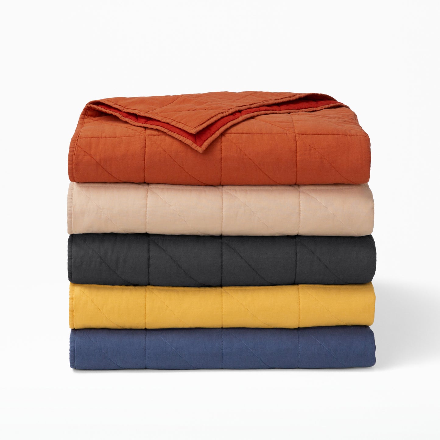The Tuft and Needle Quilt folded and stacked||color:charcoal
