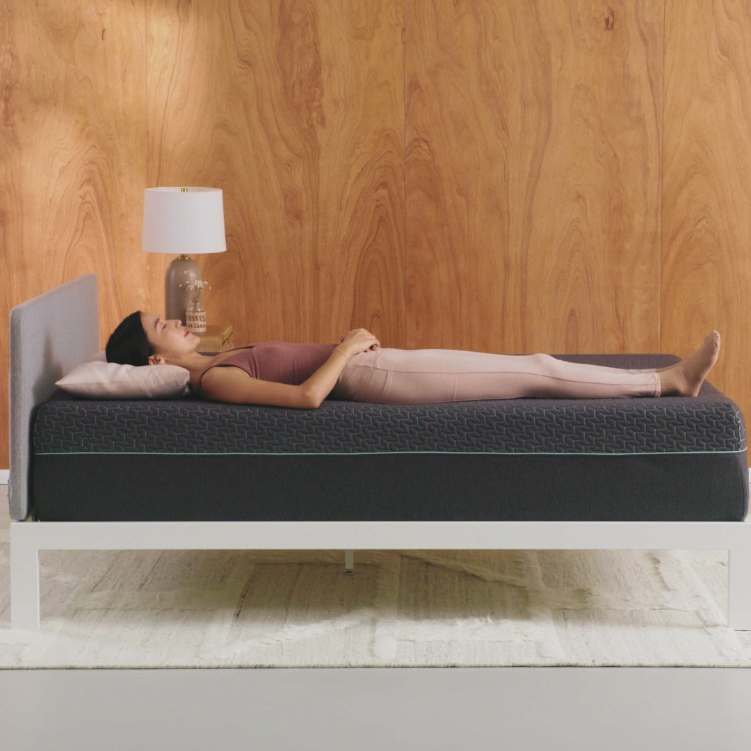 Tuft & Needle Mint Hybrid Mattress short video showing a woman laying on her back the turning onto her left side