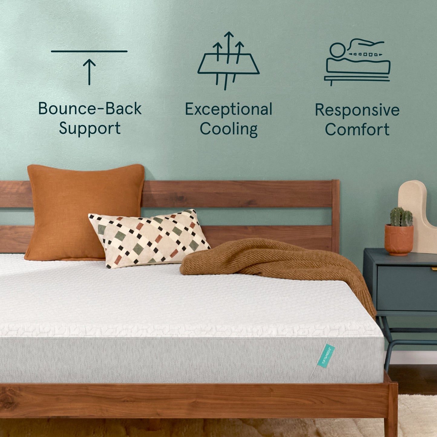 Tuft & Needle Original Mattress sitting in a brown bedframe with 2 pillows on top of it and a brown blanket with a chart on the wall showing icons reflecting Bounce-Back Support, Exceptional Cooling and Responsive Comfort