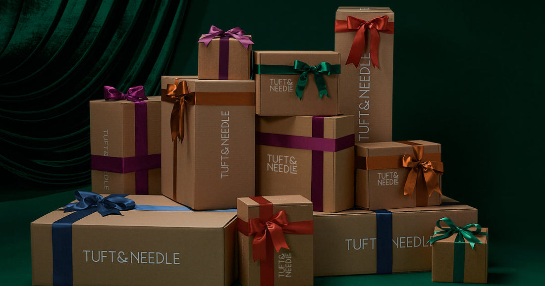 A bunch of Tuft & Needle product boxes with bows on them making them look like holiday presents