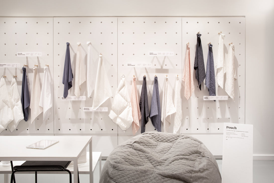Picture of one of the walls inside a T&N Retail Store with samples of sheets hanging on the walls