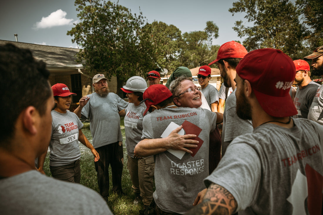 Picture of Team Rubicon coming together and hugging after a hard days work