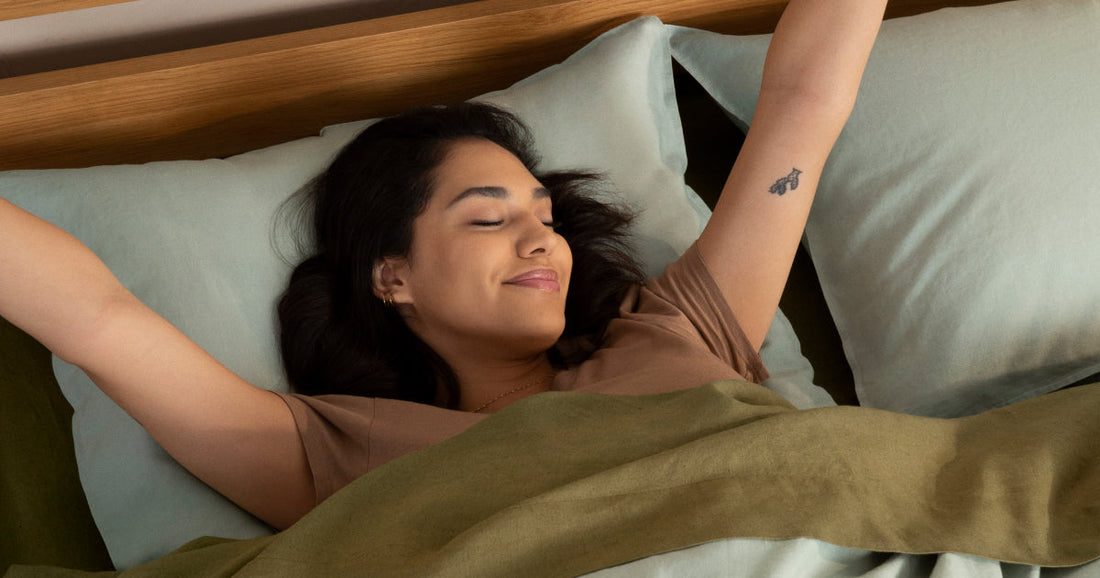 Woman laying on her back stretching and smiling