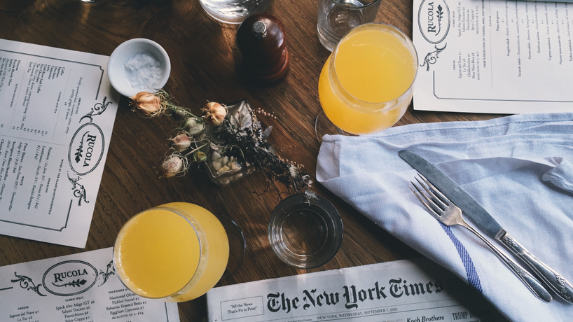 Arial view of a table at a restaurant with menus and mimosas on it