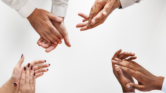 Picture of 4 different sets of hands clasped together