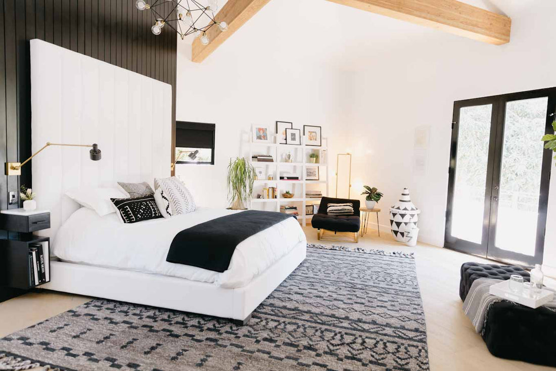 Keltie Knights black and white designed bedroom with wood ceiling beams