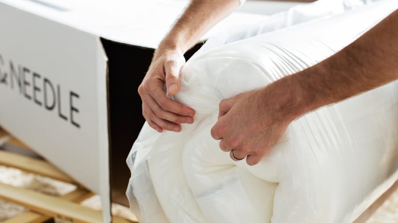 Hands unboxing Original Mattress