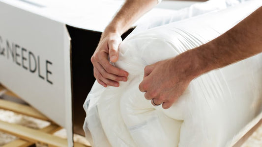 Hands unboxing Original Mattress