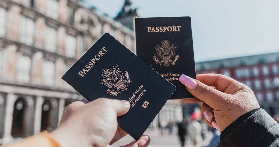 Picture of two passports being held up in front of a building