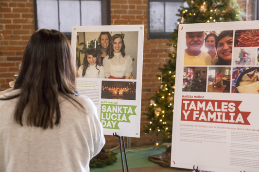 Woman looking at Family Tradition Poster Boards made by Tuft & Needle Employees