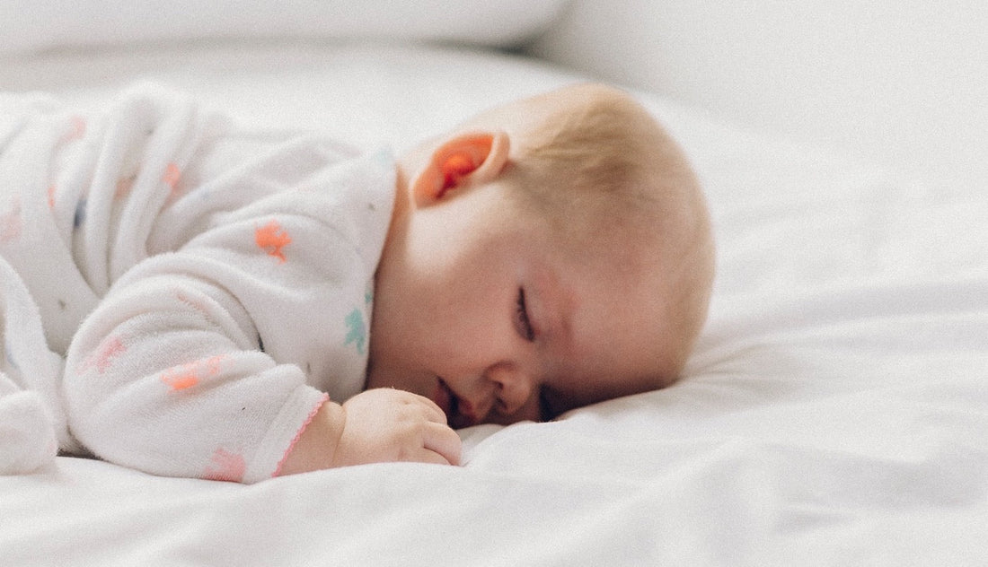 Picture of a baby sleeping on its stomach