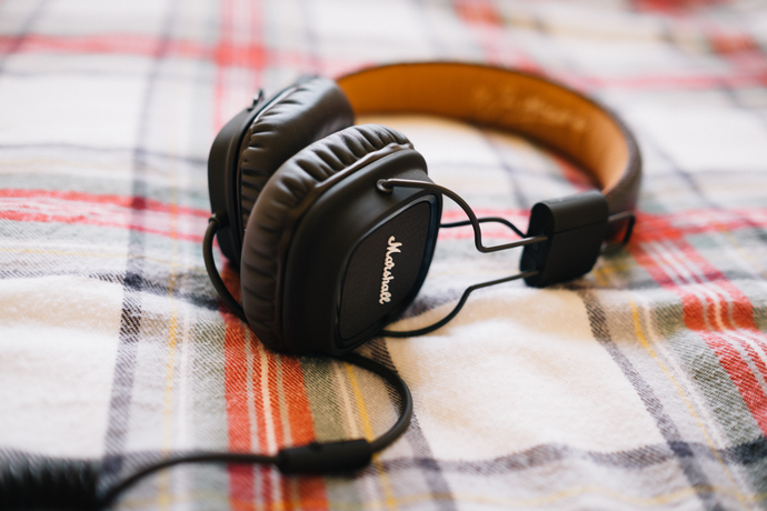 Over the ear headphones laying on a flannel sheet