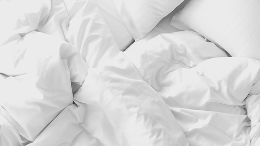 Crumpled up white bedding