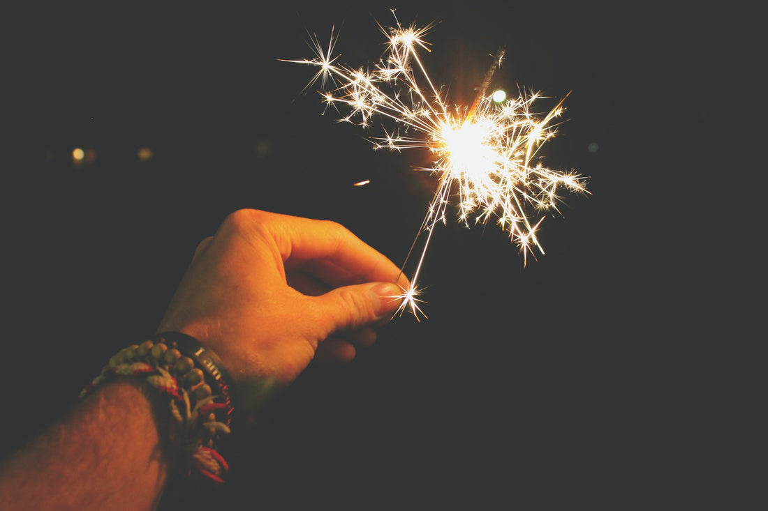 Hand holding a sparkler.