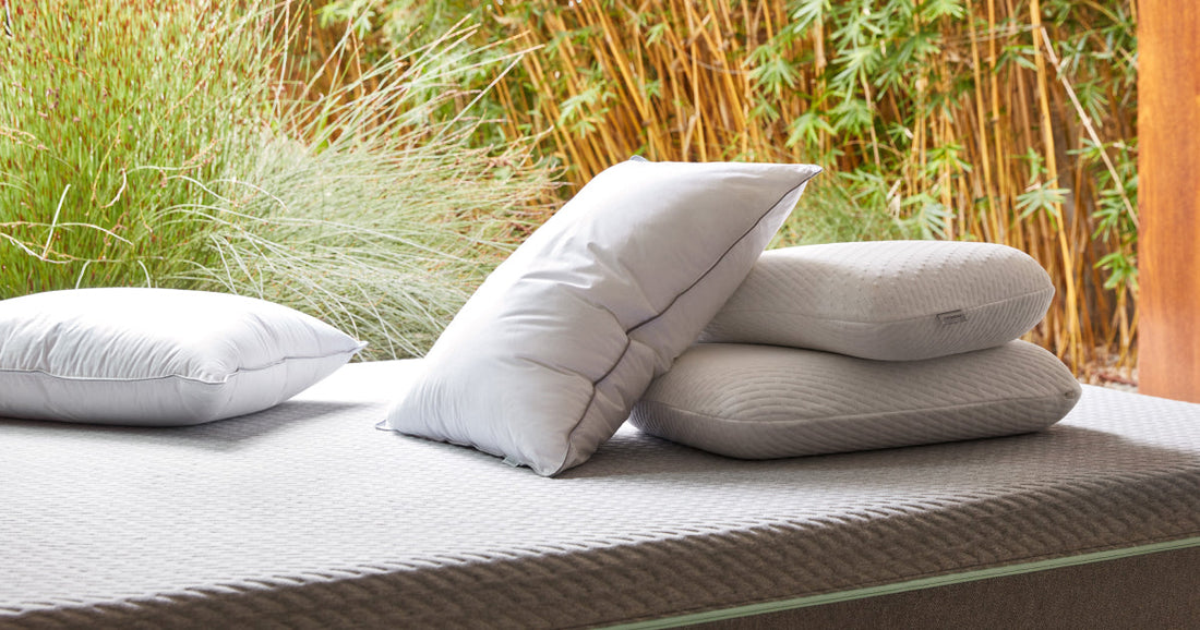 Tuft & Needle Foam and Down Pillows sitting on top of an unmade T&N Mattress