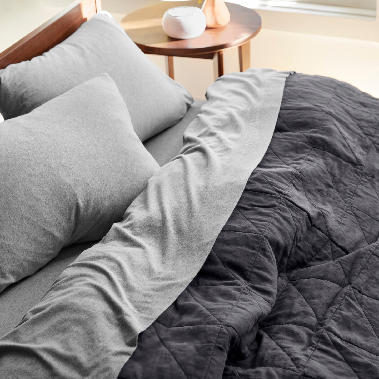 Organic Jersey sheets on a Tuft and Needle mattress with a blanket on to and 2 pillows
