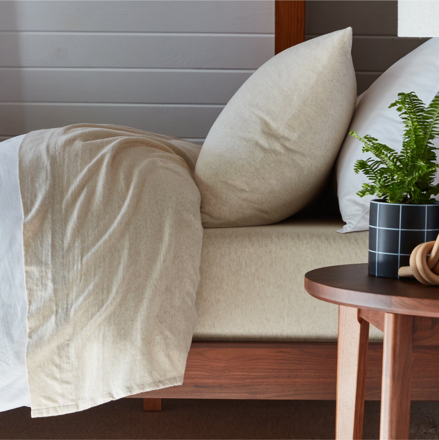 Cream organic jersey sheets on a tuft and needle mattress