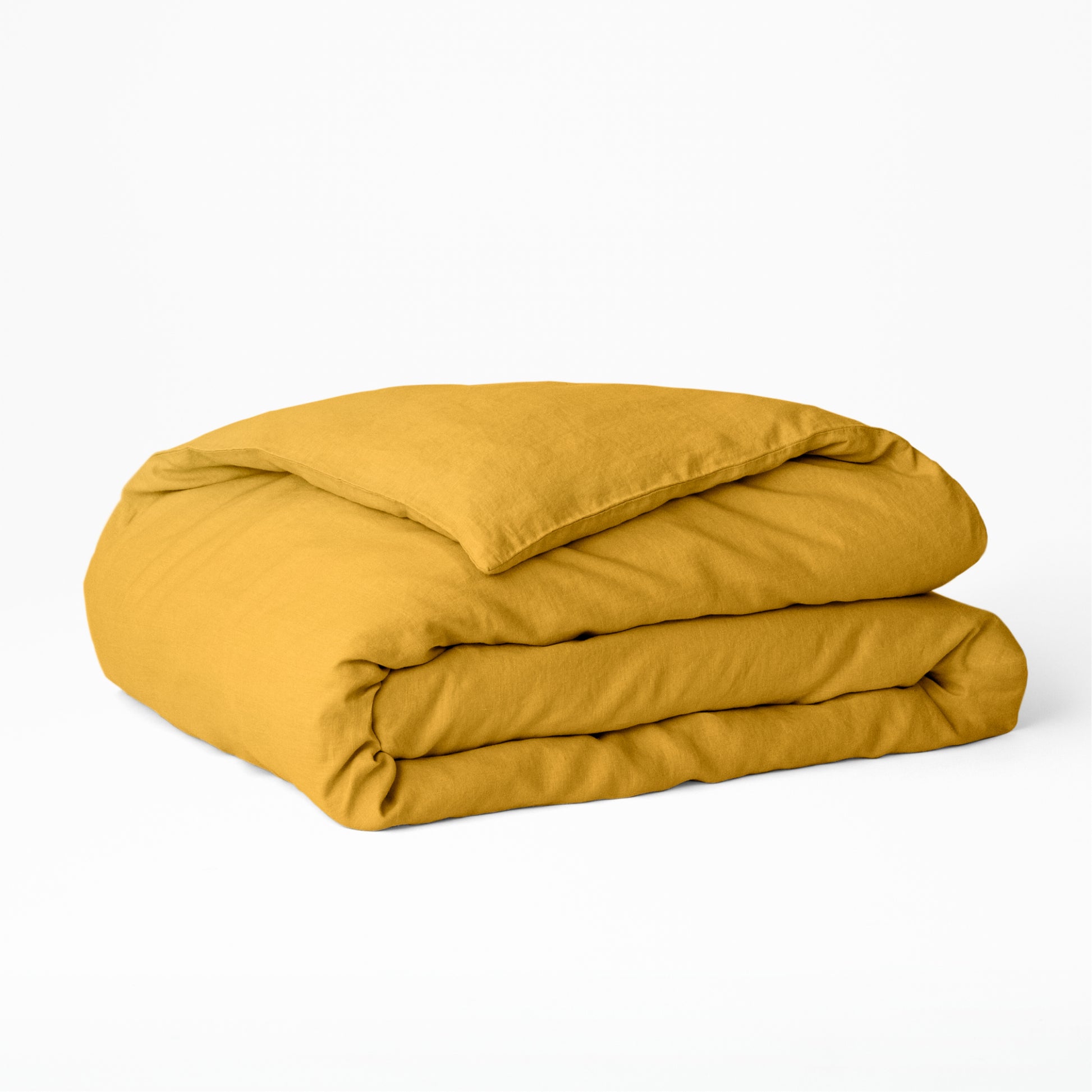 The Tuft and Needle Hemp Duvet Cover folded on a white background||color:honeycomb
