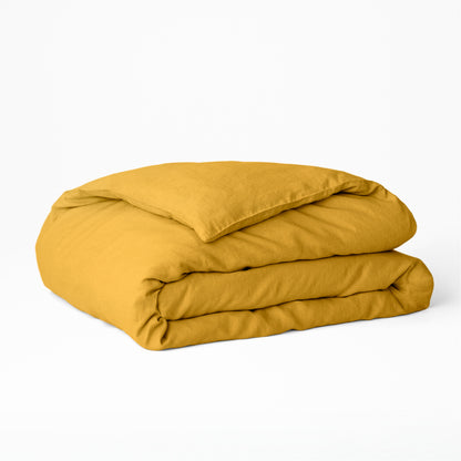 The Tuft and Needle Hemp Duvet Cover folded on a white background||color:honeycomb