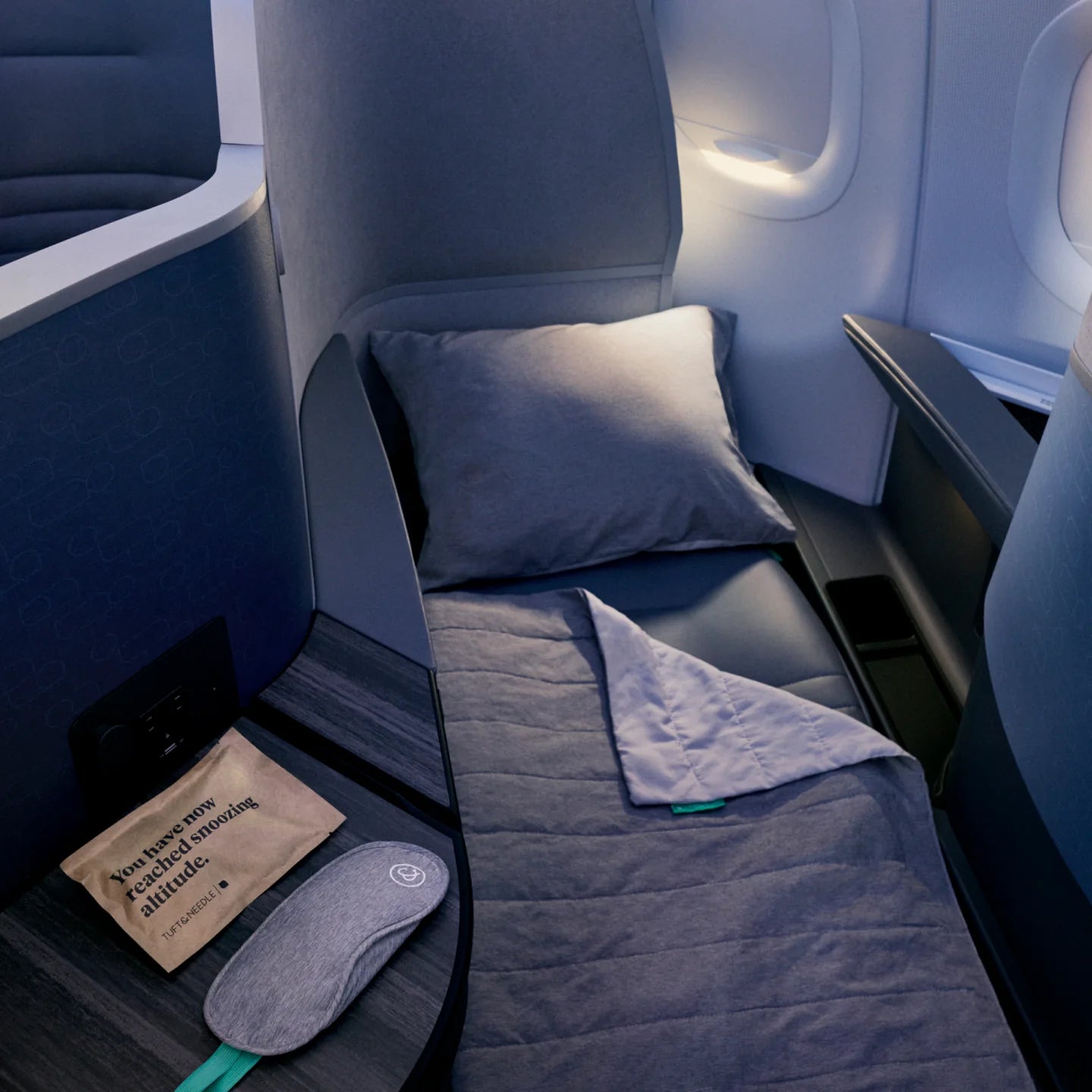 The cabin of a JetBlue airplane with T&N sleep mask 
