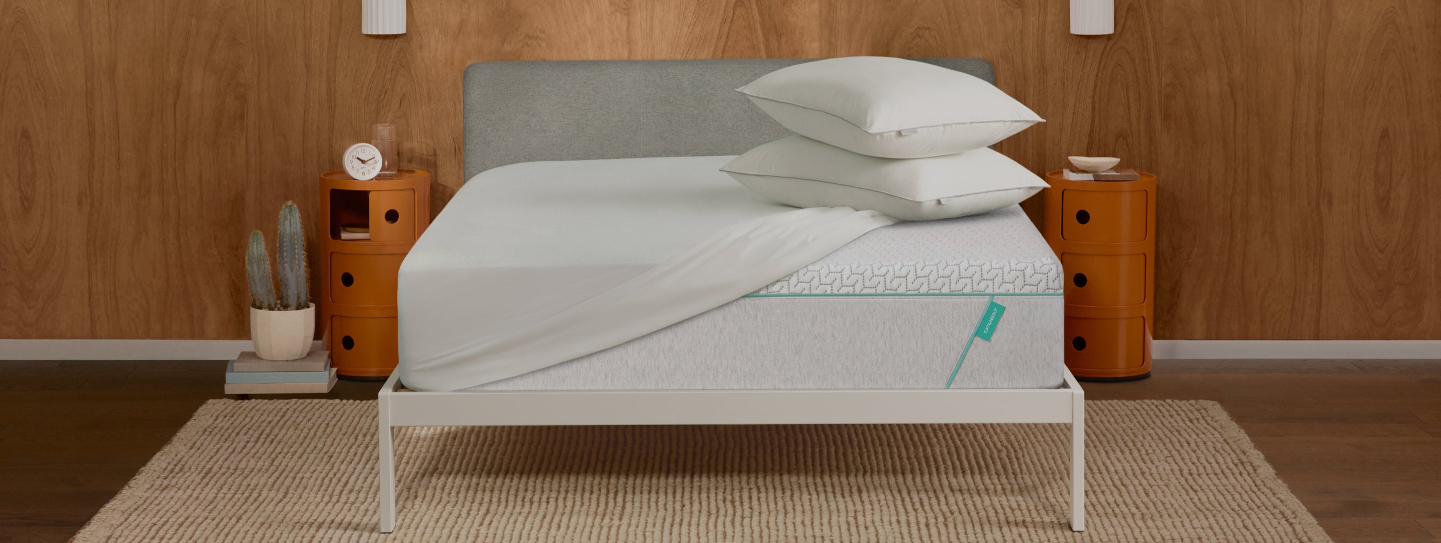 Tuft and Needle Bundles image showing white bedding, two pillows on top of a Tuft and Needle mattress.