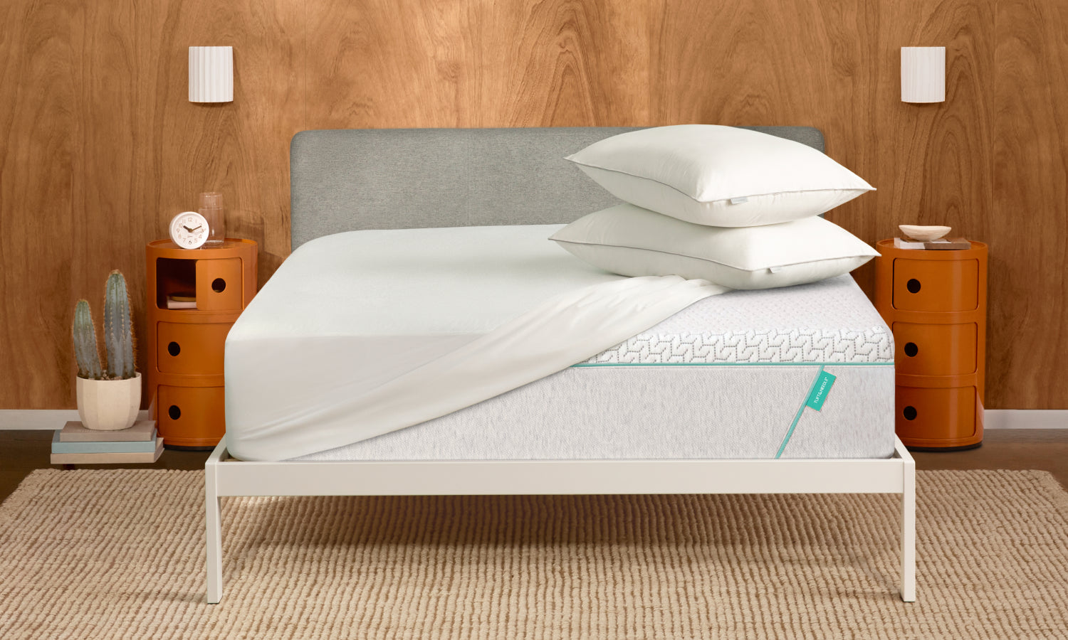 Tuft and Needle Bundles image showing white bedding, two pillows on top of a Tuft and Needle mattress.